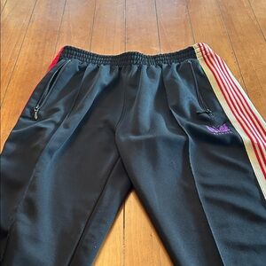 Needles Track Pants - Black with Red and Gold Stripes